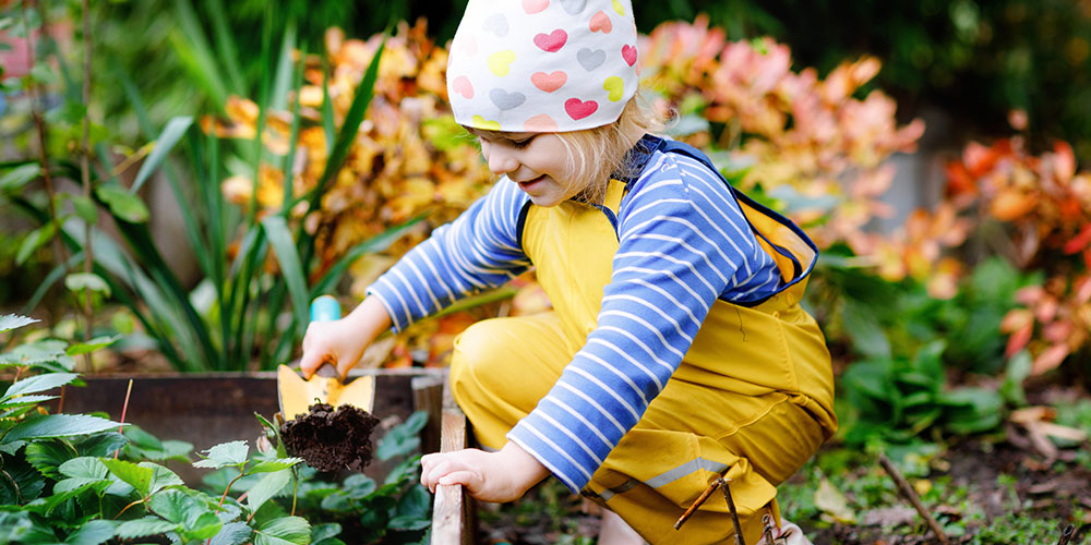 Pine Hills Nursery-Mississippi-How to Get Kids Excited About Veggie Gardening-child in garden